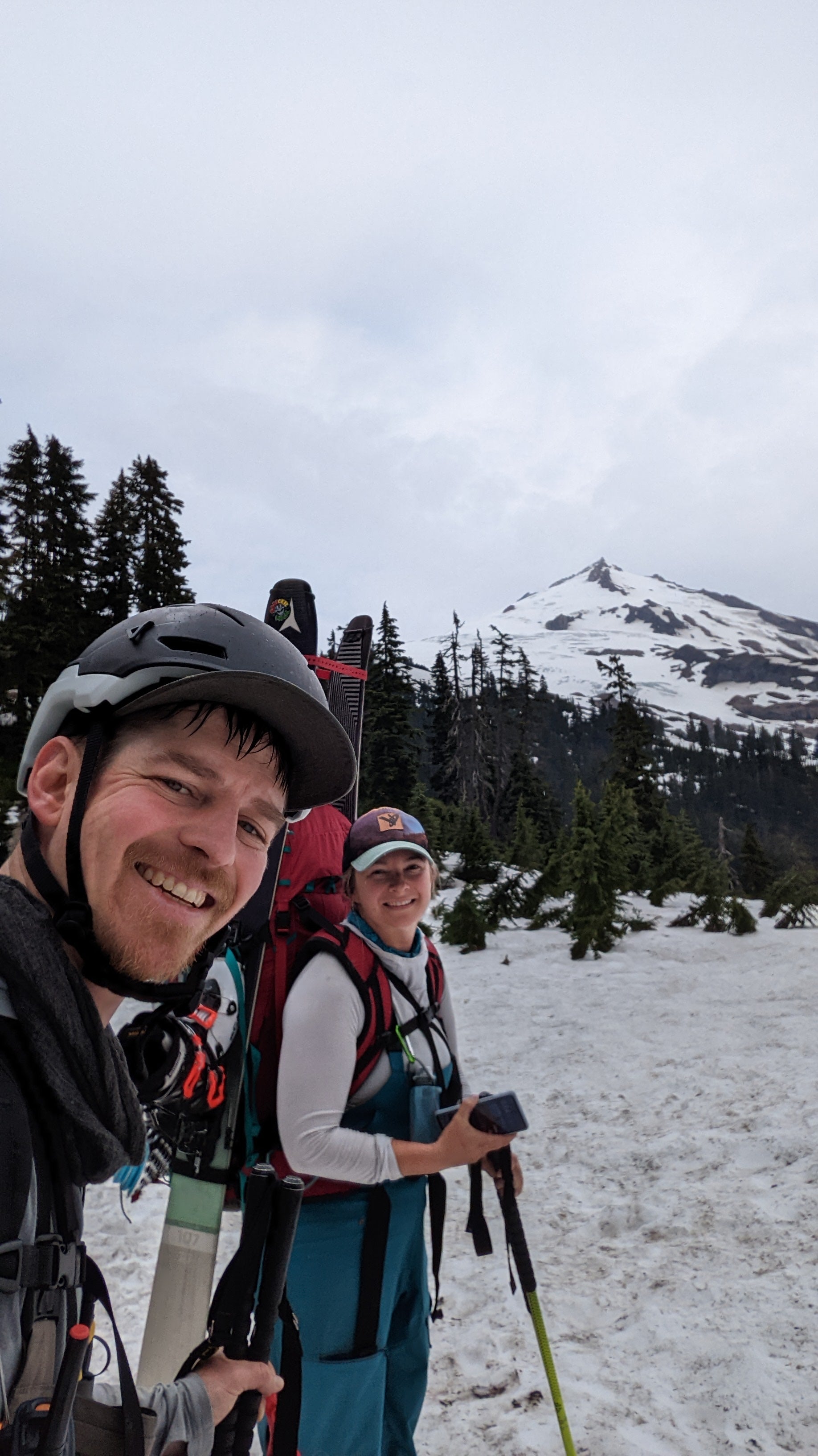 two people with skis on snowy mountain